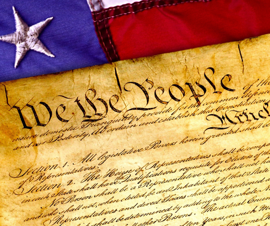 A close-up of the U.S. Constitution, highlighting the phrase “We the People,” symbolizing the foundation of due process rights for all individuals.